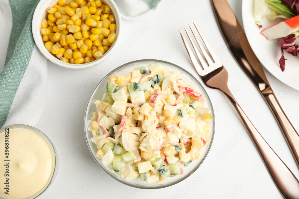 Delicious salad with fresh crab sticks and corn served on white table, flat lay Delicious salad with fresh crab sticks and corn served on white table, flat lay