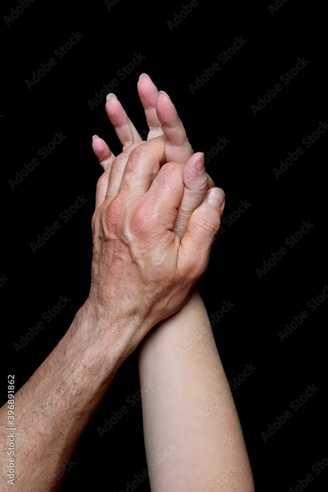 male and female hands together on black background, old skin with wrinkles and veins, concept of health, age-related changes, love, tender relationship of a couple in love, isolated image male and female hands together on black background, old skin with wrinkles and veins, concept of health, age-related changes, love, tender relationship of a couple in love, isolated image