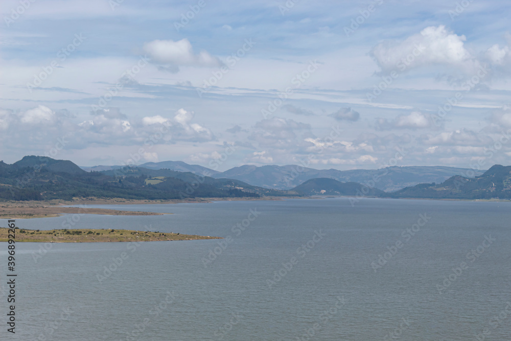 Colombia Guatavita Tomine reservoir blue lake with mountains and blue cloudy sky at sunny day.  