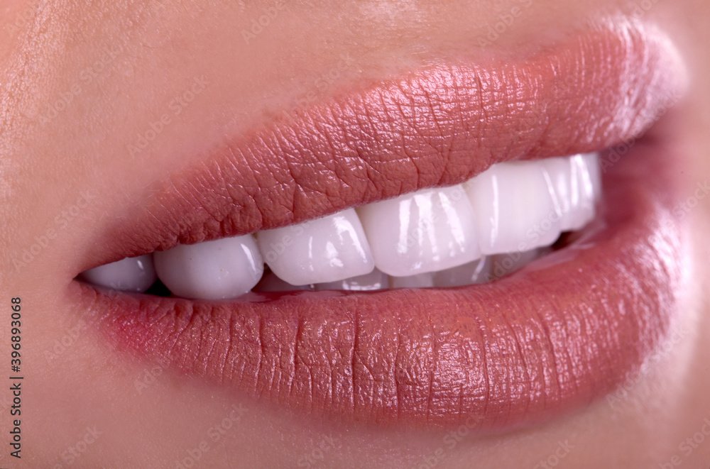 Fototapeta premium Perfect healthy teeth beautiful wide smile bleaching ceramic crowns whitening of young smiling attractive sexy lips woman. Dental zircon implants restoration treatment Close Up surgery dentistry 