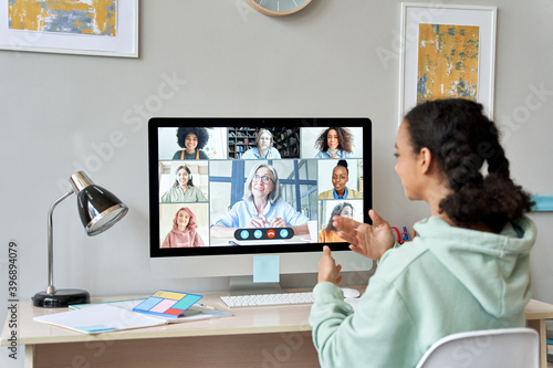 Φωτογραφία African teen high school girl college student distance learning virtual remote class, group online interactive lesson on video conference call talking with teacher on computer screen studying at home