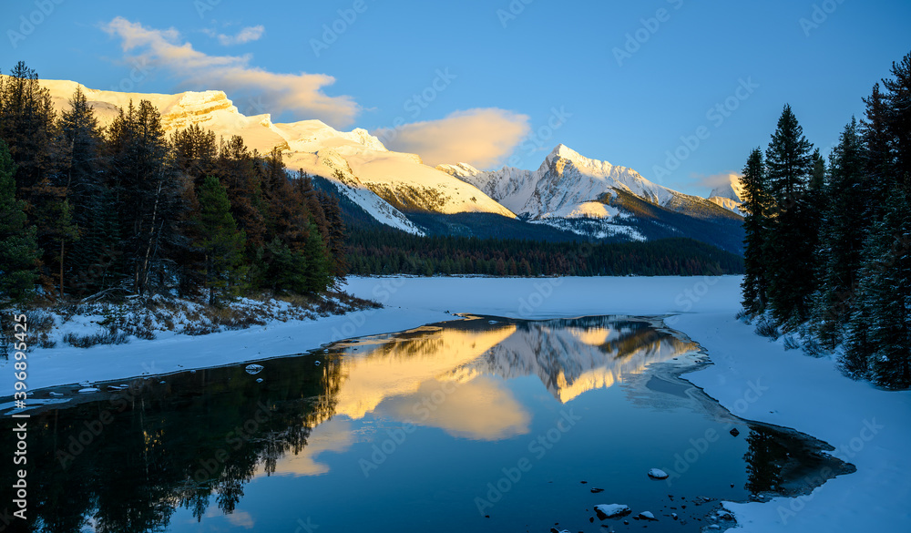 The frozen Maligne Lake with Queen Elizabeth Ranges in the background in the Jasper National Park