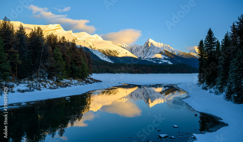 The frozen Maligne Lake with Queen Elizabeth Ranges in the background in the Jasper National Park