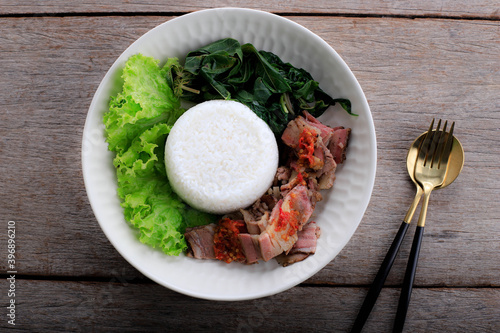 Se'i Sapi or  Beef Sei is Indonesia Traditional Smoked Beef, Served with Boiled Cassava Leaves and Sambal Luat or Sambal Matah. Typically Food from Nusa Tenggara, Indonesia photo