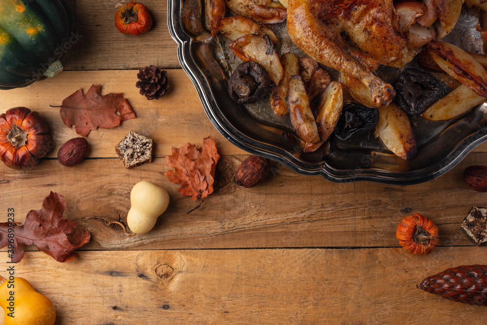 Round dish with baked turkey and potato on wooden background. Festive dinner. Thanksgiving concept. Traditional Christmas meal. view from above. Flay lay. Space for text. Round dish with baked turkey and potato on wooden background. Festive dinner. Thanksgiving concept. Traditional Christmas meal. view from above. Flay lay. Space for text.