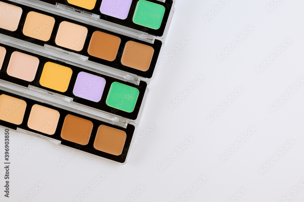 Professional pallet of eyeshadow multicolor bright make up on isolated white background Professional pallet of eyeshadow multicolor bright make up on isolated white background