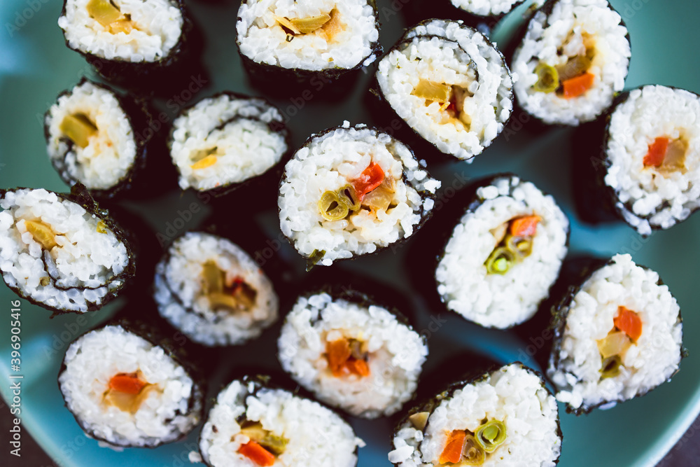 plant-based food, homemade vegan sushi with stir fried vegetable filling