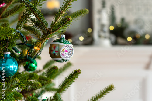 Closeup of a vintage Christmas ornament on a live tree photo