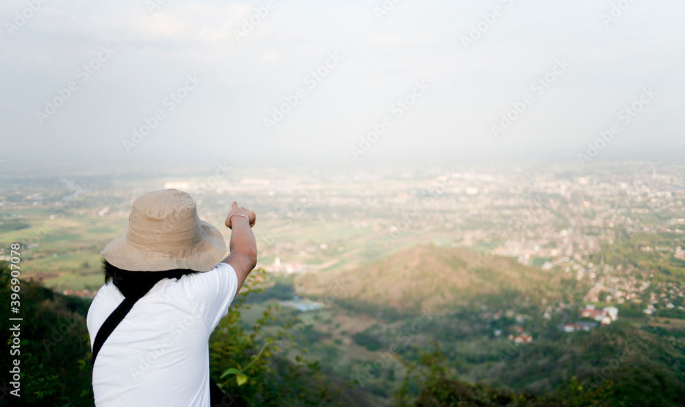 rear view of person pointing the view in the mountains rear view of person pointing the view in the mountains