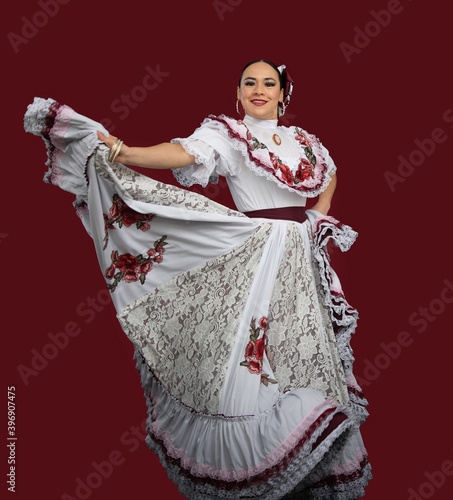 mexican latin woman with traditional folk costume with multicolored background, dancer and mexican model posing traditional folk clothing