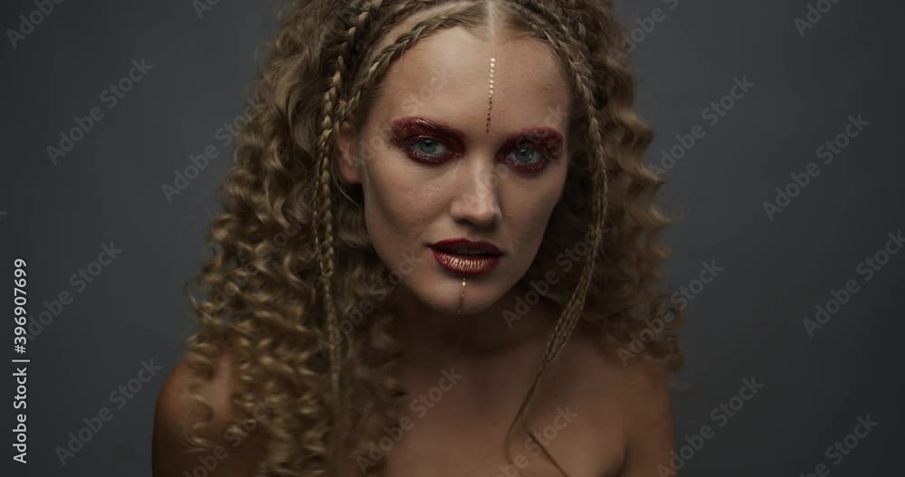 Fashion industry, young blonde lady with bright red and gold makeup is posing 4k Fashion industry, young blonde lady with bright red and gold makeup is posing 4k
