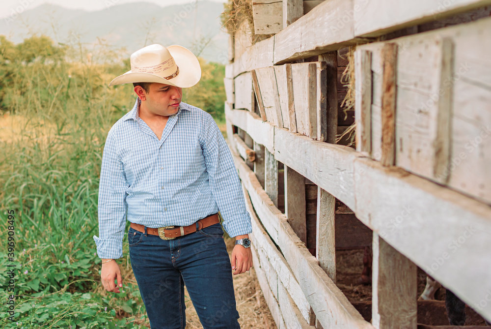 cowboy standing on fence