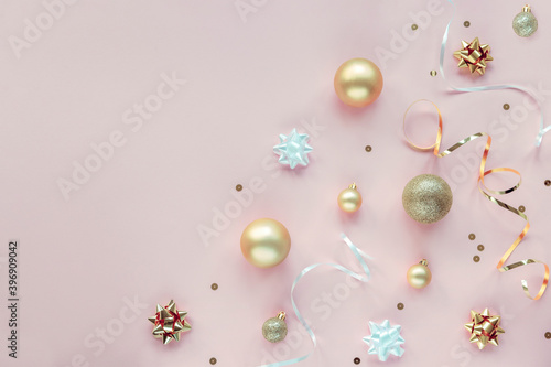 Pink New Year background with Christmas balls  baubles and confetti. Top view  flat lay  copy space
