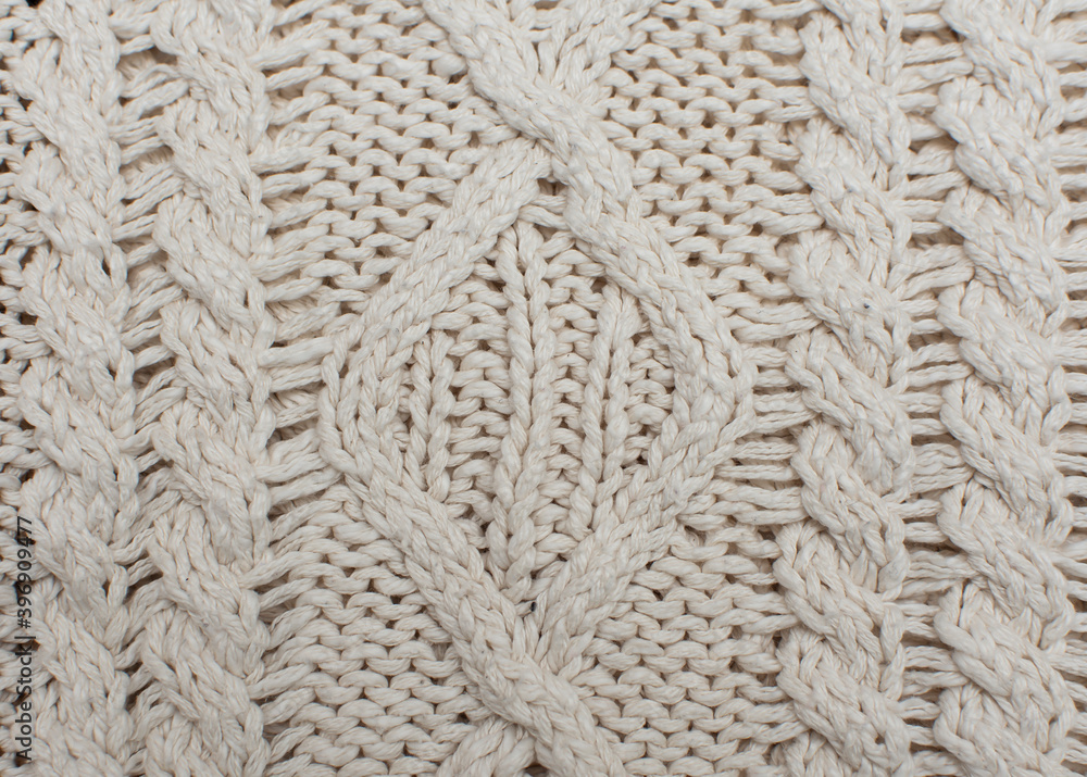 Knitted background, texture, pattern. Closeup of sample with knitting weave. Cable knitting. Knitted background, texture, pattern. Closeup of sample with knitting weave. Cable knitting.
