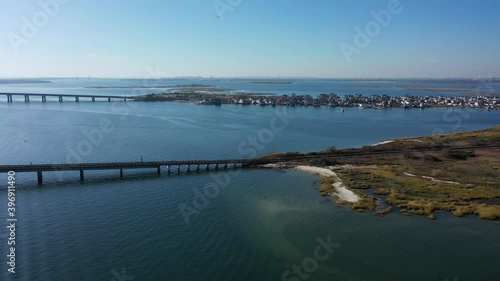 Wallpaper Mural An aerial shot of elevated train tracks with s swing bridge over a bay in Queens, NY. The camera trucks left & pan right over the water. The sun is shining on the water & it is a beautiful day. Torontodigital.ca