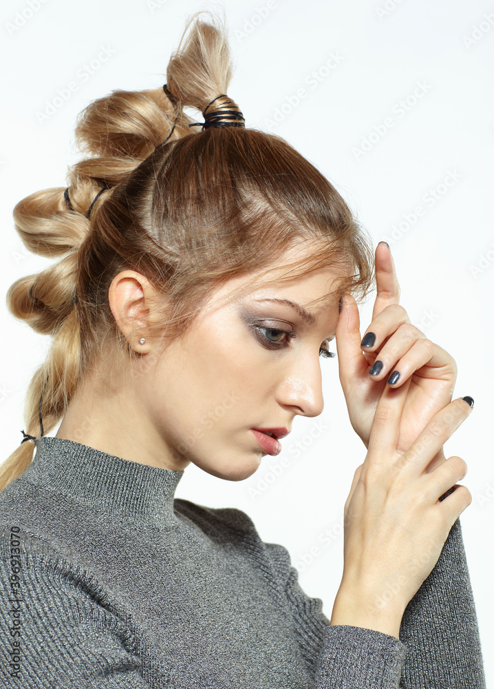 Fototapeta premium Portrait of blonde female with creative braid hairdo.