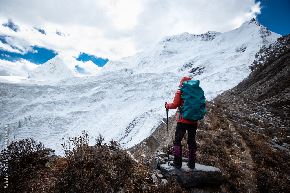 Woman hiker hiking enjoy the view on winter mountain top