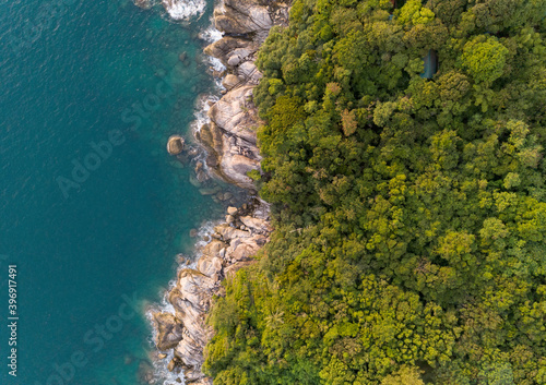 High angle view Tropical sea with wave crashing on seashore and high mountain located in Phuket Thailand aerial view drone top down Amazing nature view
