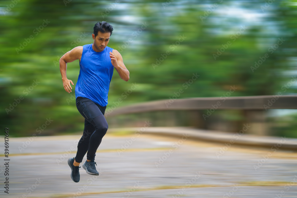 sportman runner practicing sprinting run on road in park in morning sportman runner practicing sprinting run on road in park in morning