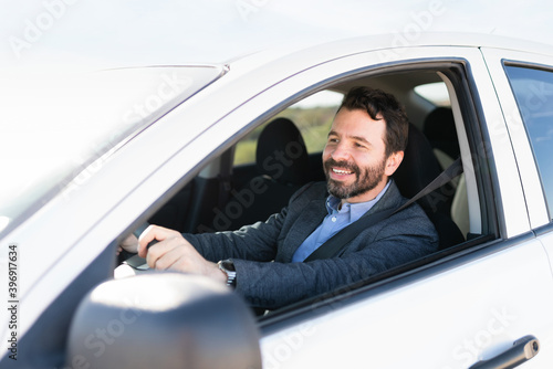 Profile of a happy male driver behind the wheel