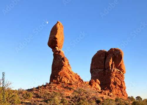 Balanced Rock formation with moon rising in the evening, Arches National Park
