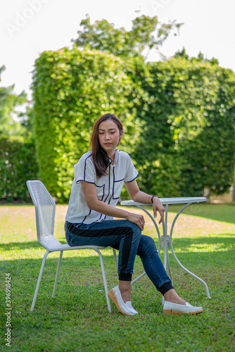 Happy day concept, portrait of beautiful  happy female relaxing outside in nature green garden. © Juraiwan