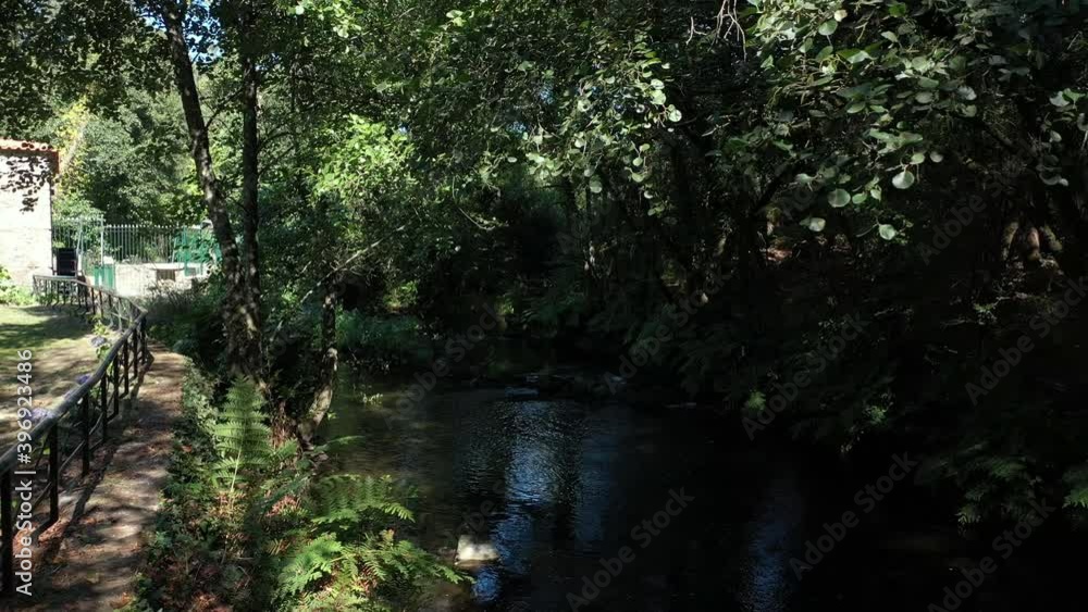 Stream next to a rural tourism house with a small water mill - Pull out low angle Aerial Stream next to a rural tourism house with a small water mill - Pull out low angle Aerial
