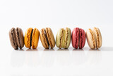 Traditional french colorful macarons in a rows, top view