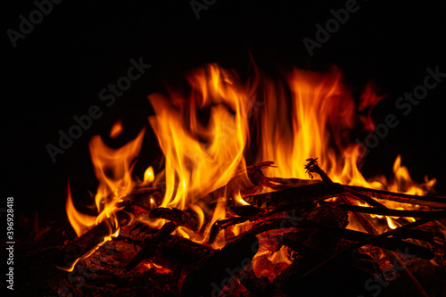 Campfire close up at night with black background. Fire heat adventure camping concept