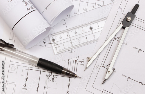 Rolled electrical diagrams and accessories for drawing. Engineer jobs concept