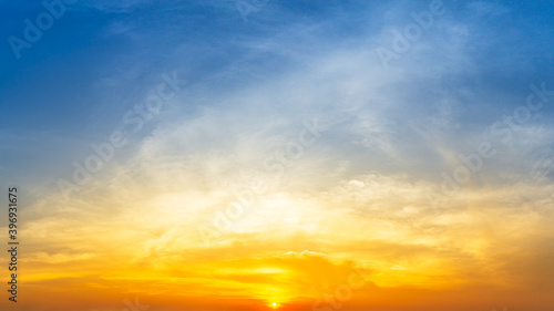 Orange sunrise and fluffy cloud sky nature background © c_atta