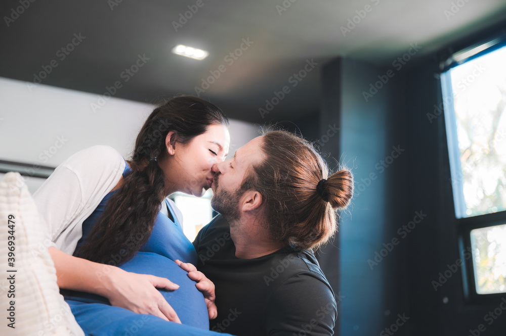 Obraz premium Happy pregnant couple waiting for baby at home, Pregnant couple of husband and wife