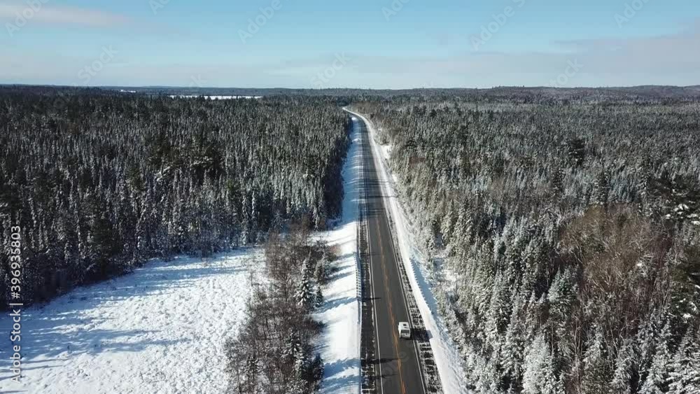 Cold sunny blue sky winter day in the northern countryside of Canada - Drone 4k Aerial Van driving Cold sunny blue sky winter day in the northern countryside of Canada - Drone 4k Aerial Van driving