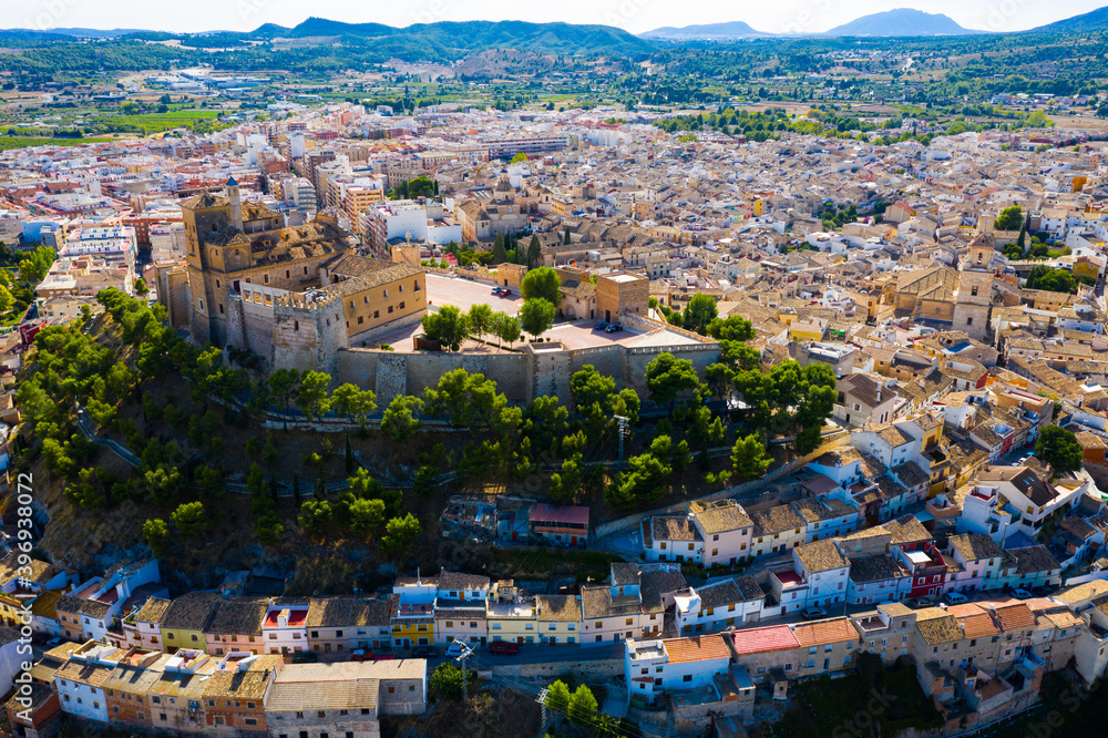 Aerial view of Caravaca de la Cruz cityscape with ancient fortified castle and Roman Catholic church, Spain