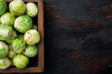 Brussels sprouts, on old wooden table, flat lay with space for text