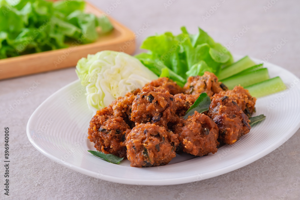 Deep fried spicy minced pork served with vegetable on plate, Thai food Deep fried spicy minced pork served with vegetable on plate, Thai food