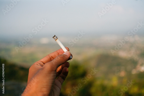 hand holding a rolled up cigarette