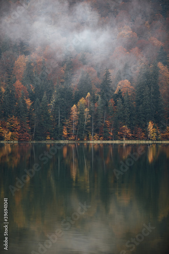 Moody autumn landscape in the foggy forest. Saint Anne Lake,Romania. © szaboerwin