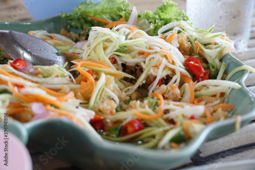 Papaya salad,food made from papaya with a variety of ingredients that are sour,sweet and spicy Is a very popular food in Thailand Anyone who eats deliciously. Somtam is yummy.Isolated white background