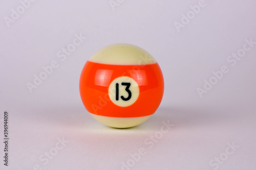 Shiny orange white ball number 13 for billiard isolated on white background