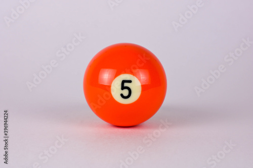 Shiny orange ball number 5 for billiard isolated on white background
