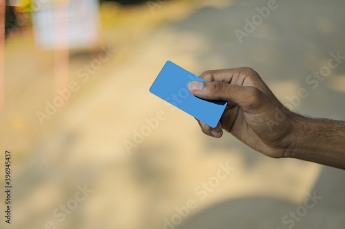 Closeup of hand of businessman holding credit card