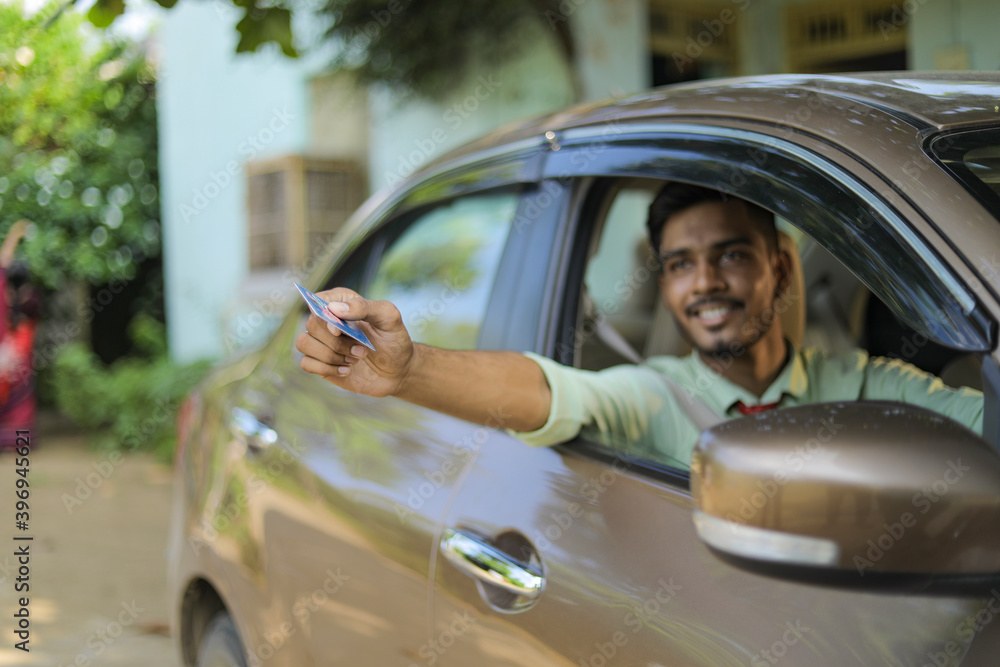 Young indian man smiling and giving his credit card Stock Photo | Adobe ...