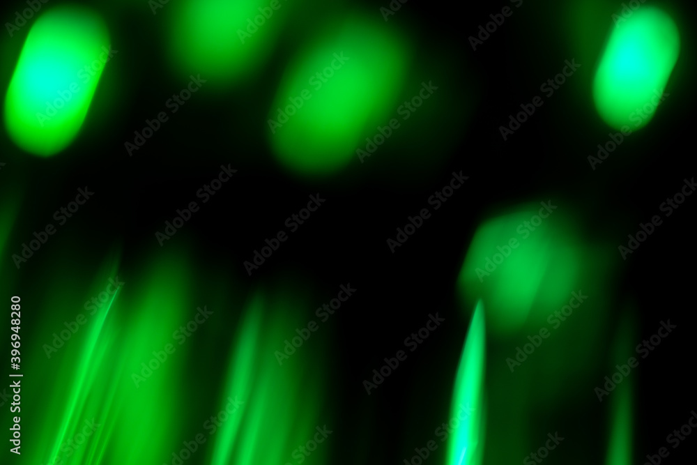 Defocused circles abstract green background of speed camera movement over glowing lights. Defocused circles abstract green background of speed camera movement over glowing lights.