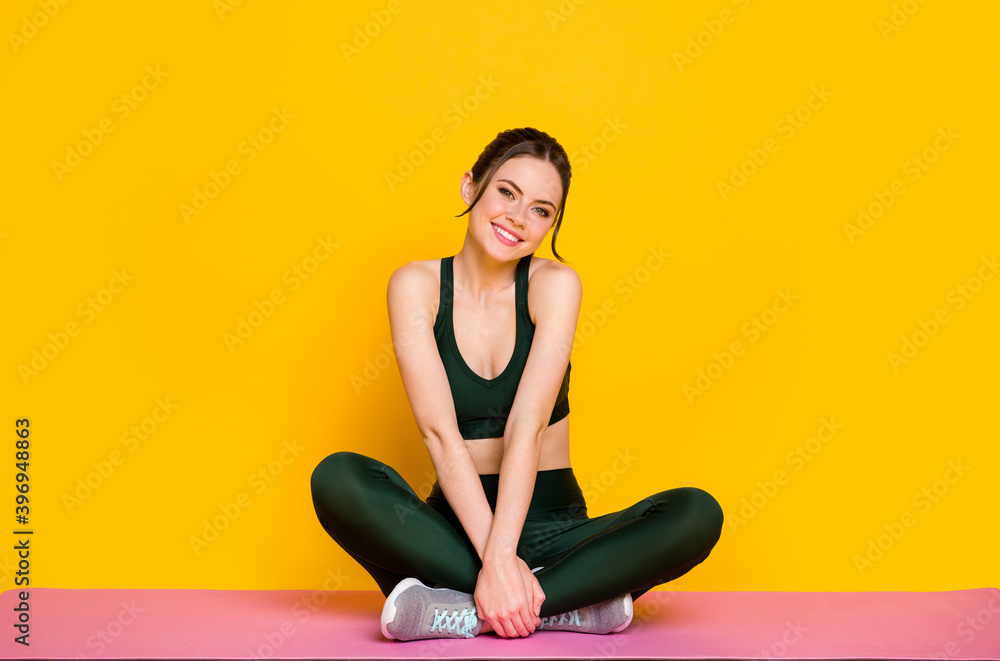 Portrait of attractive thin sportive cheery girl doing yoga class mat work enjoying isolated on bright yellow color background Portrait of attractive thin sportive cheery girl doing yoga class mat work enjoying isolated on bright yellow color background