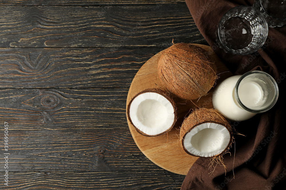 Fresh coconut and coconut milk on wooden background Fresh coconut and coconut milk on wooden background