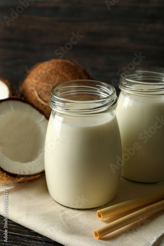 Fresh coconut and coconut milk on wooden background