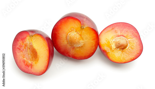 Cut plums isolated on white background