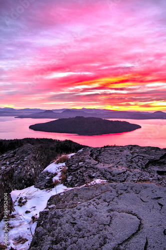 鮮やかな色彩に染まる雲の広がる風景。空の色を映す湖を見る峠からの眺め。