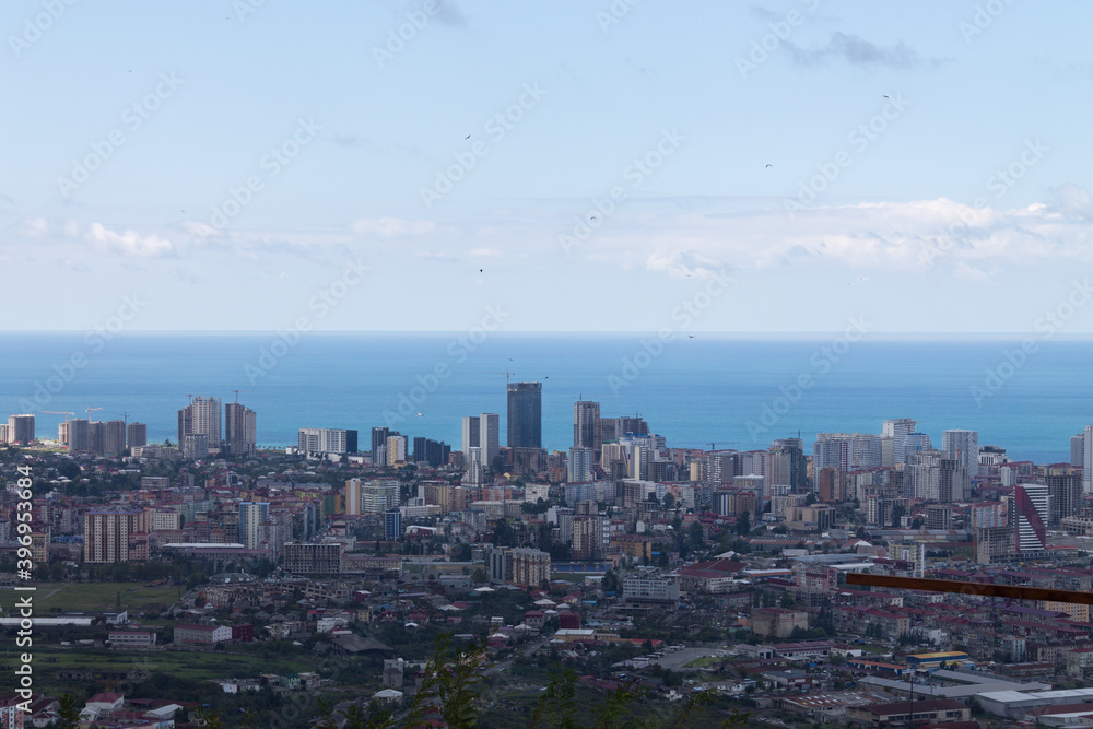 Evening Batumi on the background of the black sea and blue sky. Top view. Space for text, design cards, calendars, or posters. Georgia.